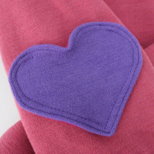 Bottom Additions- Heart Cargo Pocket. A cargo pocked in the shape of a heart that is lined in our lightweight merino wool. The heart has a double stitch around the outside. This pair has a purple heart on pink pants.