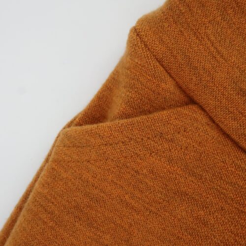 Bottoms Additions- Full Hidden pockets. The top corner of the pants trimmed and folded down with another piece of wool secured behind to create the pocket. We line the pockets with lightweight merino wool. These come as a set of 2. The thread is barely visible at the top with just 2 lines of stitching. All parts of these pockets including stitching are a saffron colour, for a more blended look.