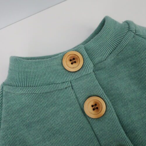 Merino Wool Button-Up Cardigan Sweater. This sweater has buttons the whole length of the sweater on a button panel that also runs the whole length of the sweater. There are options for a cuffed or hemmed bottom and sleeves are cuffed. Neck can be a short collar, tall collar, or a hood. This one is light green sweater with a small collar and medium sized light wood buttons.