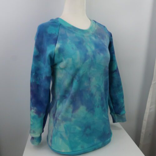 Merino Wool Simple Crew Neck Sweater. With cuffed raglan sleeves and a classic rounded crew neck. This sweater is a tie dyed blue/purple colour.