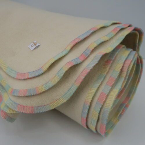 Blanket. Merino wool. Natural colour with pastel rainbow thread