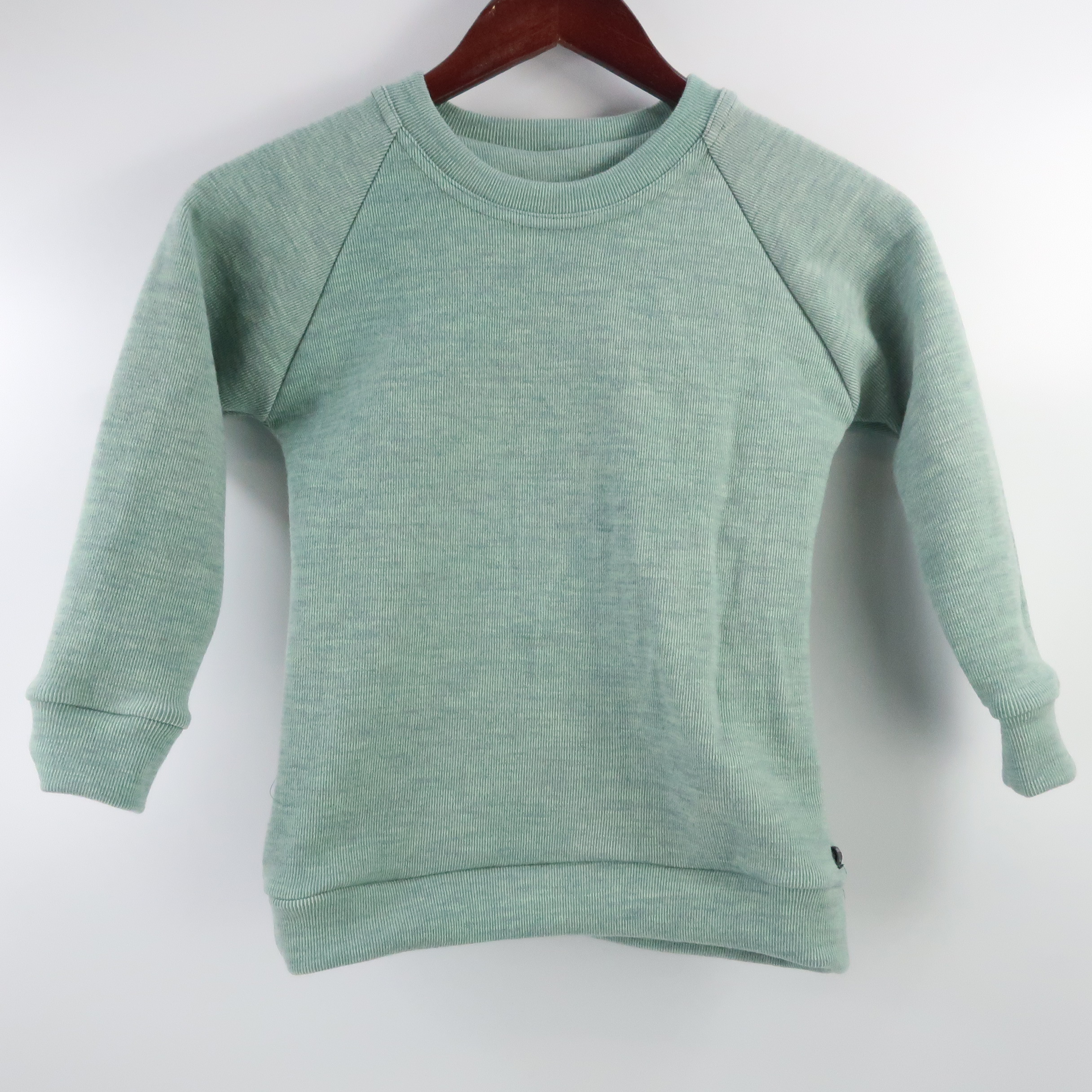 Merino Wool Simple Crew Neck Sweater. With cuffed raglan sleeves and a classic rounded crew neck. This sweater is a striped light green colour.