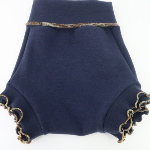 Our Brief Fit Wool Diaper Cover. This cover is a bit taller and more trim fitting that our Traditional style of cover. The leg cuffs are also small/tighter and longer. This cover is a dark denim colour with a foldover waistband and double ruffled cuffs with variegated gold thread to make it look like jeans.